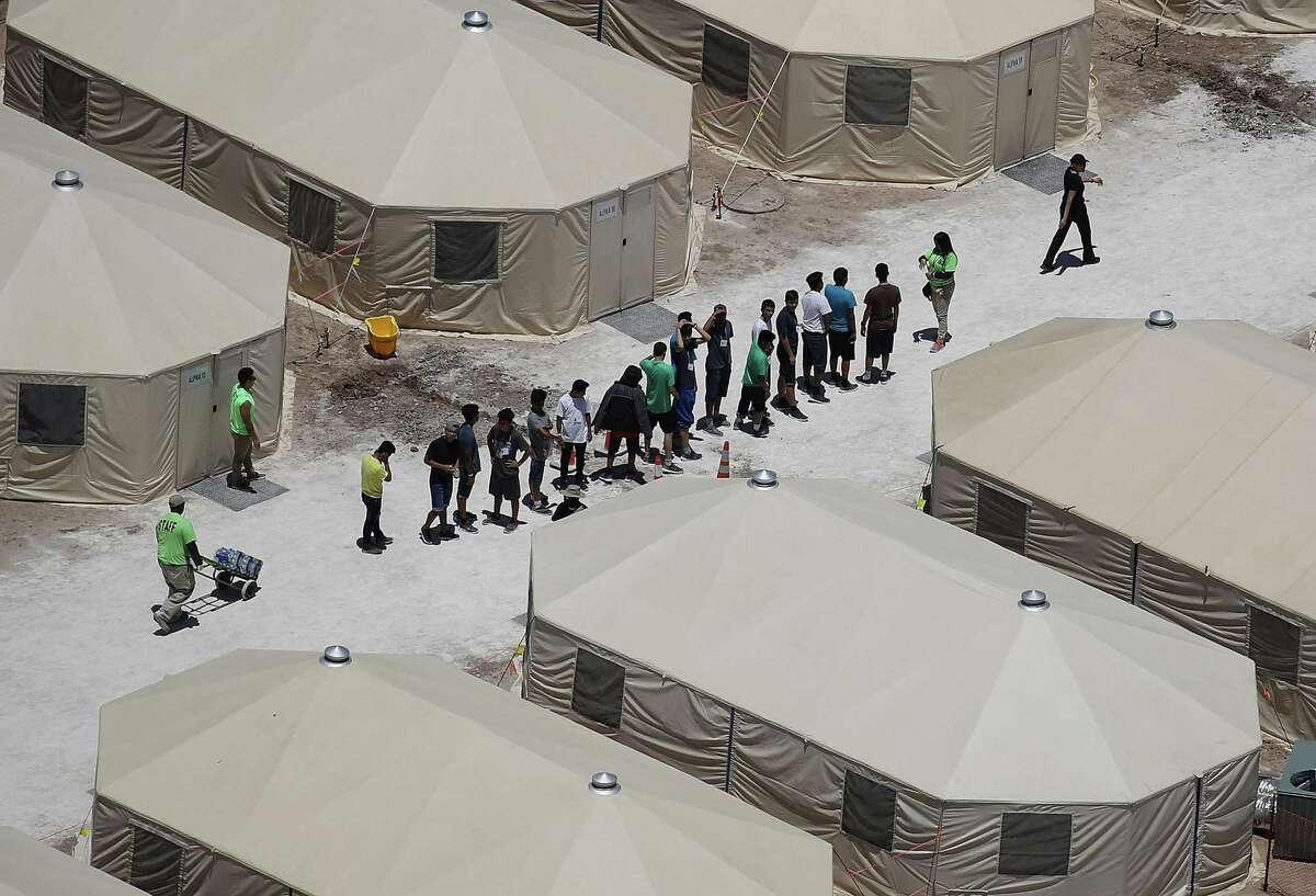 Children and workers are seen at a tent encampment recently built near the Tornillo Port of Entry on June 19, 2018 in Tornillo, Texas. The human fallout from the Trump administration's abruptly canceled policy of separating children from their parents at the U.S. border has reached California, with about 100 children now living in state-licensed group care and foster homes here.