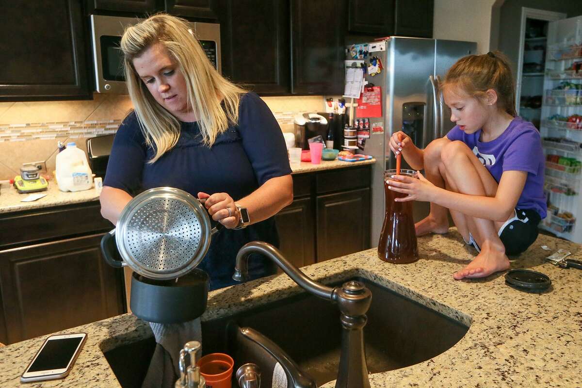 Jennifer Nolan makes a pot of macaroni and cheese while her daughter, Kenzi Nolan, 8, stirs a pitcher of tea at their home in the Sablechase subdivision in the Fair Oaks Ranch area. The family moved to Bexar County from the St. Louis area in August 2017. They wanted to settle in an area with a highly rated school district and liked that their new neighborhood was tucked away from the rush of a big city.