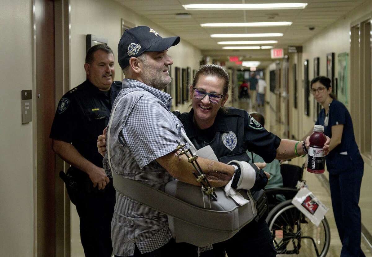 John Barnes gets a hug from Cibby Moore, a fellow Santa Fe ISD police officer, as he is released from the hospital Wednesday, June 20, 2018, more than a month after being shot in the line of duty during the May 18 shooting at Santa Fe High School.