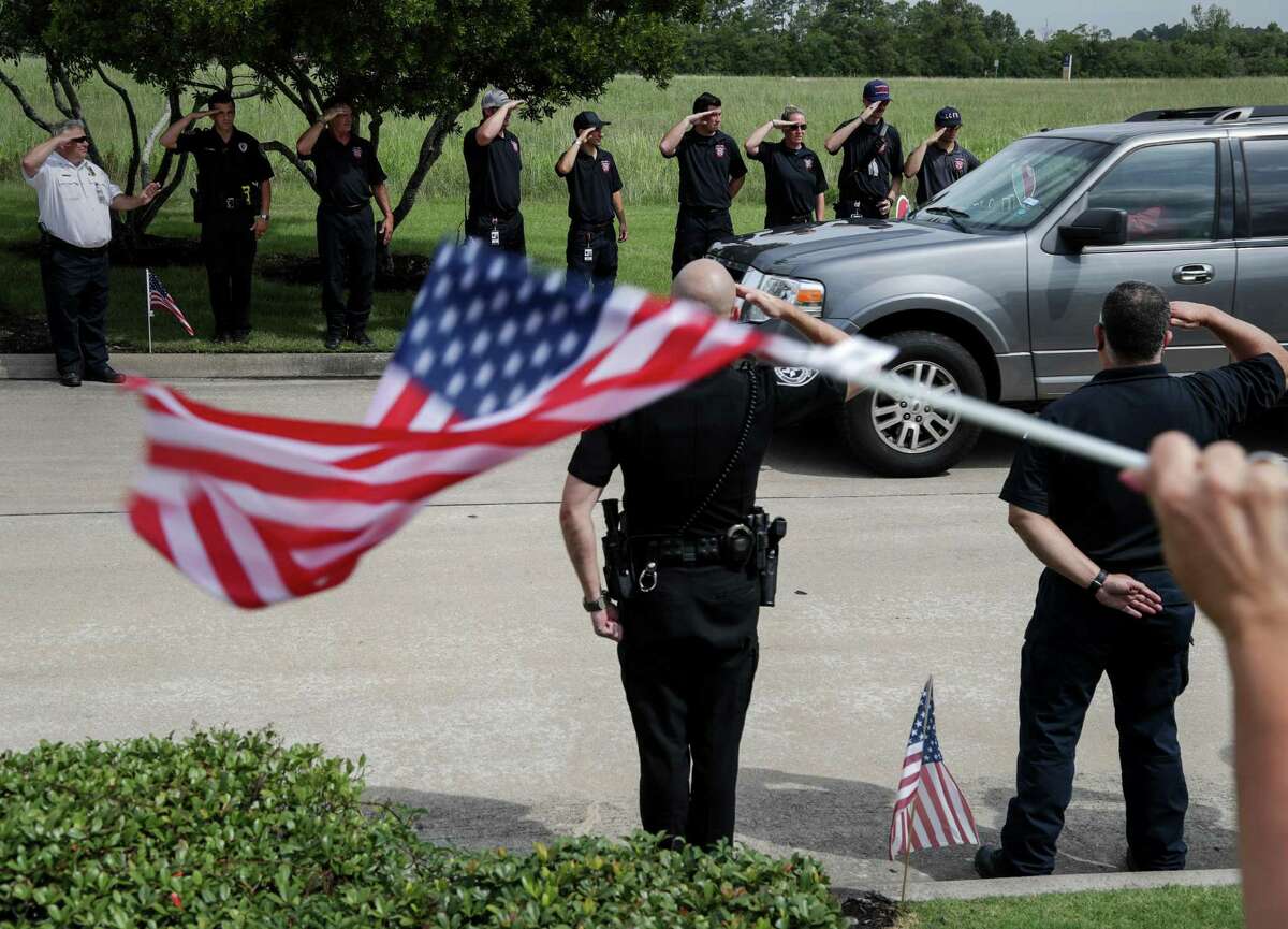 Well-wishers greet Santa Fe ISD Police Officer John Barnes as he returns to his League City home on Wednesday, June 20, 2018 after being released from the hospital more than a month after being shot May 18 in the line of duty during the Santa Fe High School shooting.