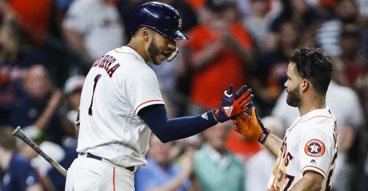 Houston Astros shortstop Carlos Correa (1) and second baseman Jose Altuve high five as they celebrate Altuve's solo home run off of Tampa Bay Rays starting pitcher Nathan Eovaldi during the sixth inning of a major league baseball game at Minute Maid Park on Wednesday, June 20, 2018, in Houston. It was his second home run of the game. ( Brett Coomer / Houston Chronicle )