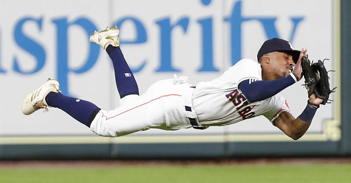 Houston Astros left fielder Tony Kemp (18) makes a diving catch on a fly ball to left by Tampa Bay Rays second baseman Willy Adames to end the first inning of a major league baseball game at Minute Maid Park on Wednesday, June 20, 2018, in Houston. ( Brett Coomer / Houston Chronicle )