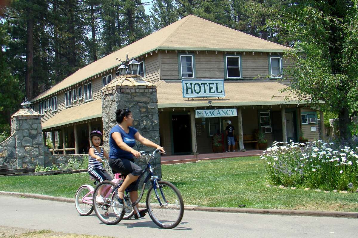 Cyclists enjoy the bike path that winds through the forest after passing in front of the hotel at Camp Richardson.
