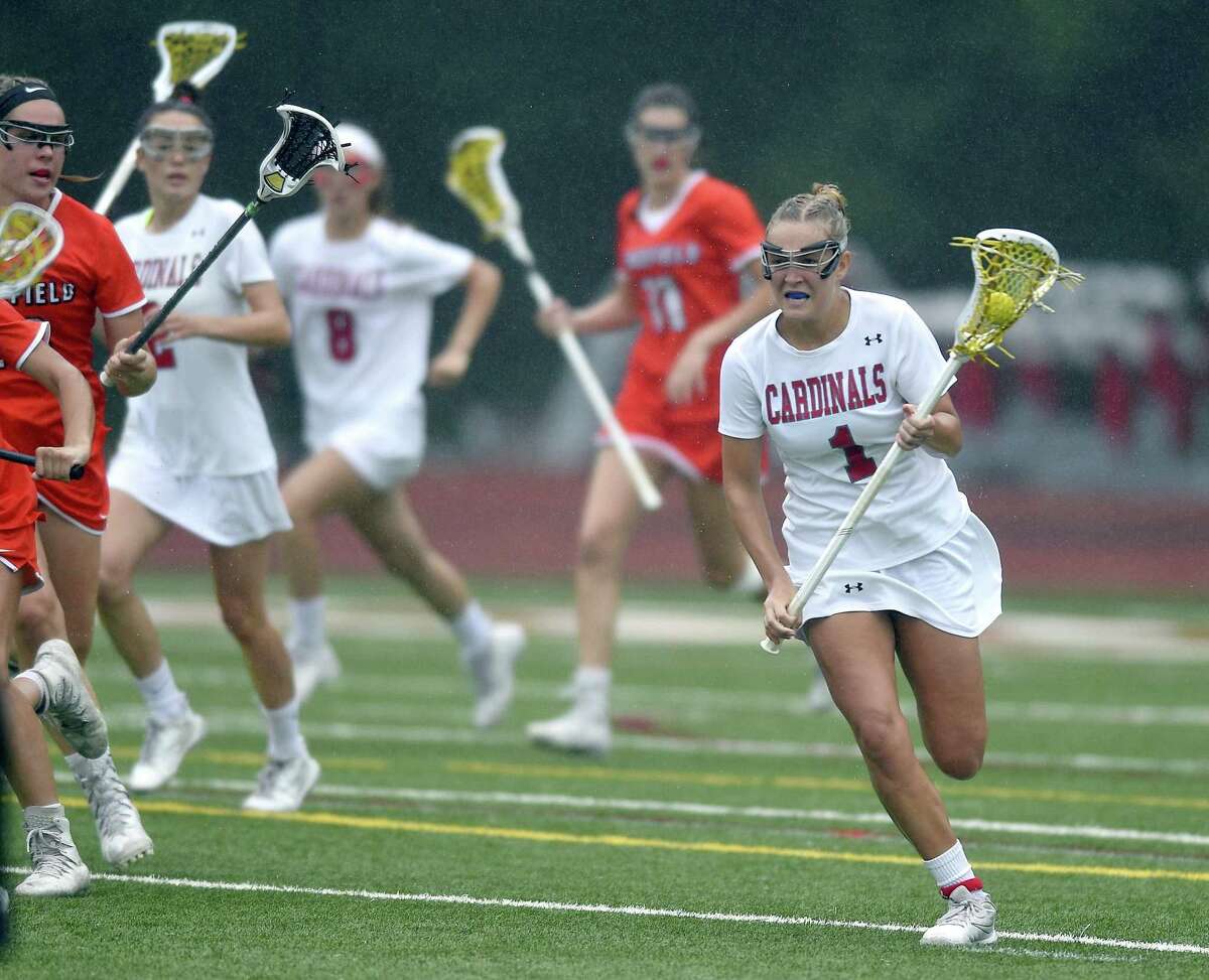 Greenwich’s Maggie O’Gorman, right, drives the ball up field against Ridgefield in a Class L quarterfinal contest against Ridgefield in lacrosse action on May 31.