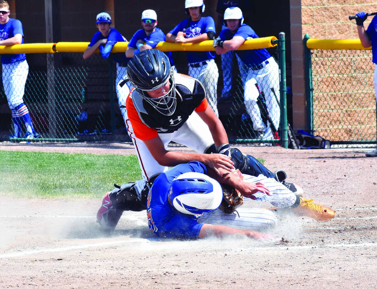 Edwardsville catcher Weston Slemmer, top, tags out the Rawlings Xtreme 18 runner at the plate during the first inning of Thursday’s game at Tom Pile Field in Edwardsville.