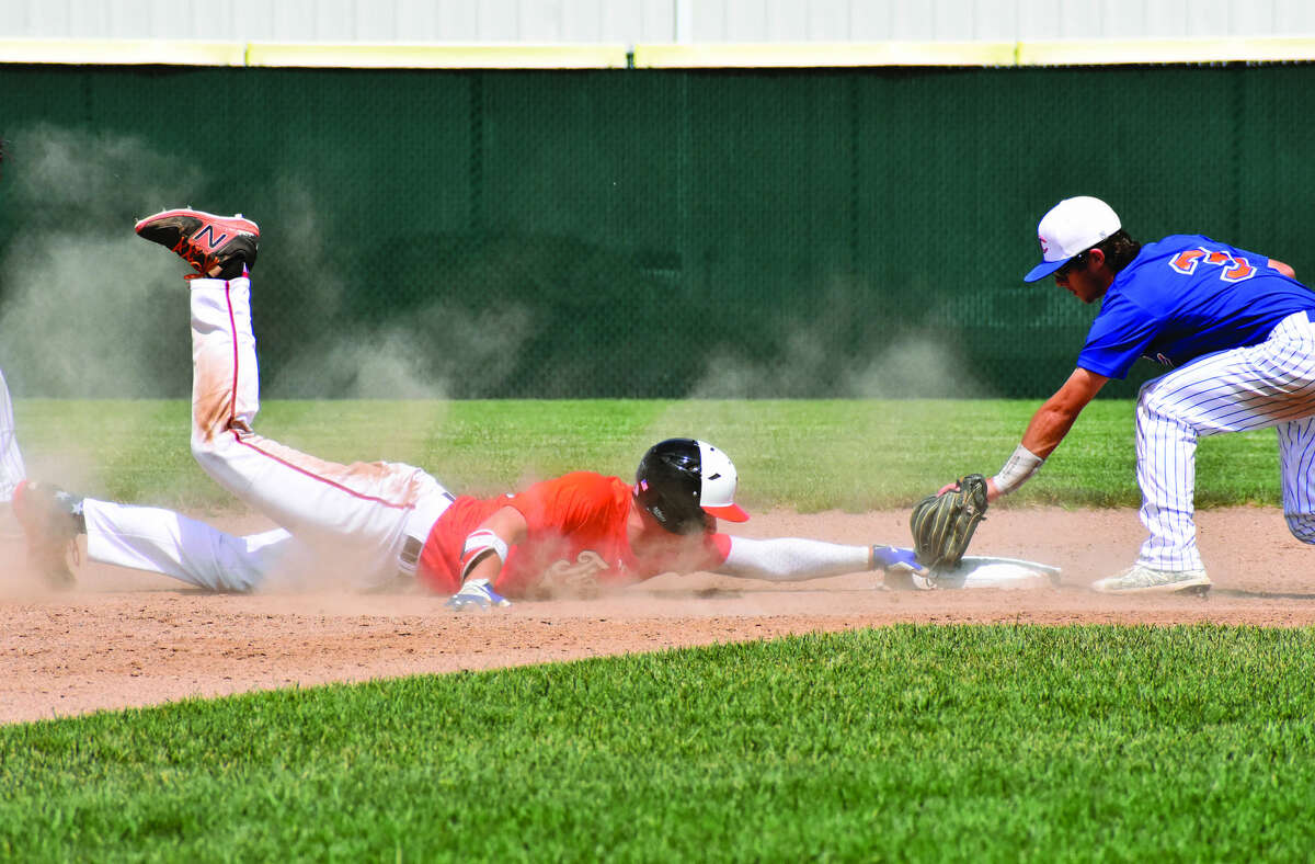 Edwardsville’s Matt Stopka holds onto second base after he slides past the bag to beat the tag from the second baseman at Tom Pile Field.
