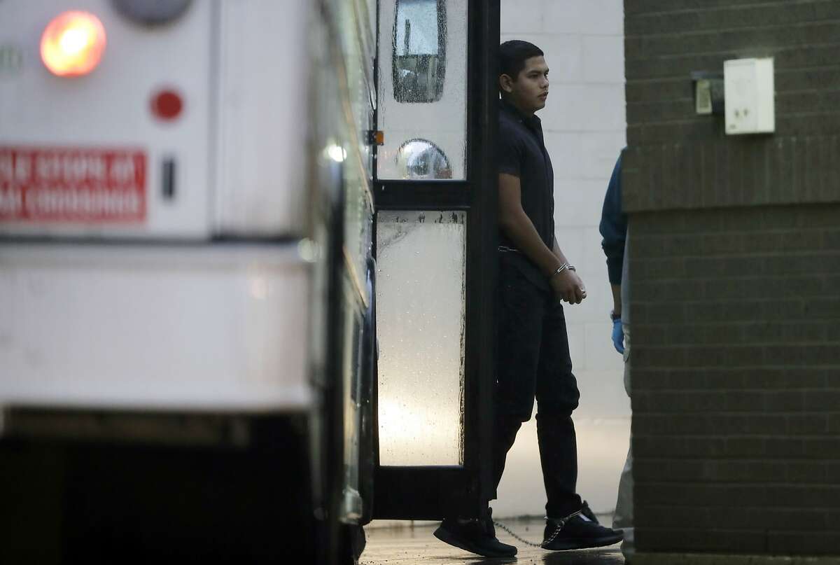 Immigrants in handcuffs and ankle chains arrive at the Federal Courthouse for hearings, Thursday, June 21, 2018, in McAllen, Texas. President Donald Trump signed an executive order Wednesday to end family separations at the border. (AP Photo/Eric Gay)