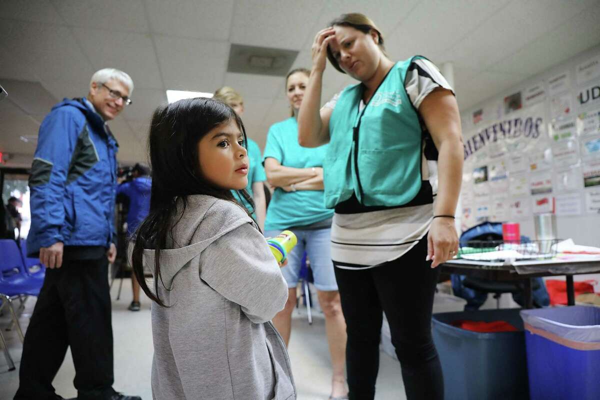 MCALLEN, TX - JUNE 21: Jenquel, who recently crossed the U.S., Mexico border with her mother and siblings, speaks with volunteers at the Catholic Charities Humanitarian Respite Center on June 21, 2018 in McAllen, Texas. Once families and individuals are released from Customs and Border Protection to continue their legal process, they are brought to the center to rest, clean up, enjoy a meal and get guidance to their next destination. Before Trump signed an executive order yesterday that the administration says halts the practice of separating families seeking asylum, more than 2,300 immigrant children had been separated from their parents in the zero-tolerance policy for border crossers. (Photo by Spencer Platt/Getty Images)