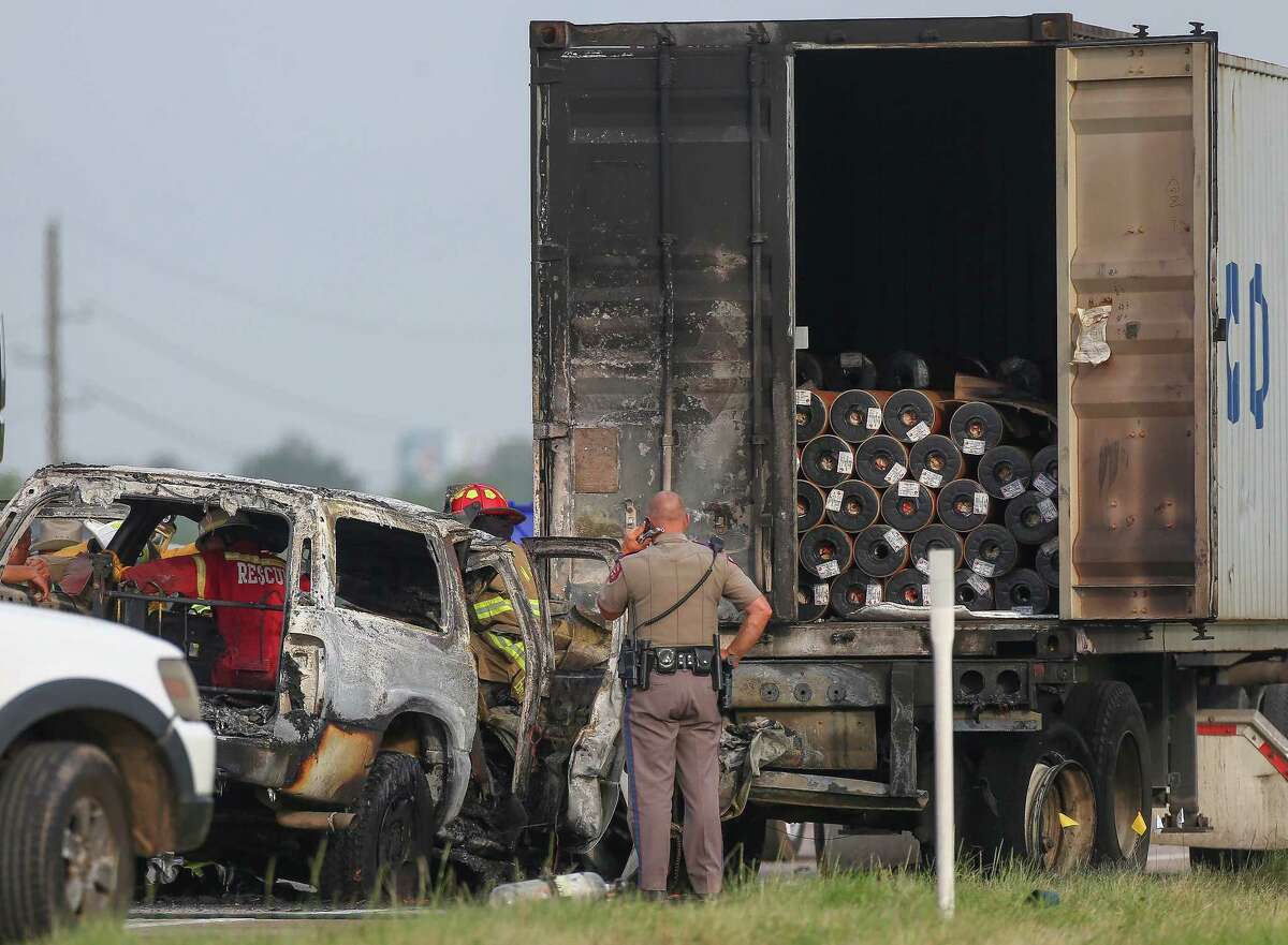 Authorities investigate the scene of a crash, where one person died in fire that resulted from the incident on the westbound lanes of Interstate 10 near Woods Road Friday, June 22, 2018, in Brookshire, Texas.