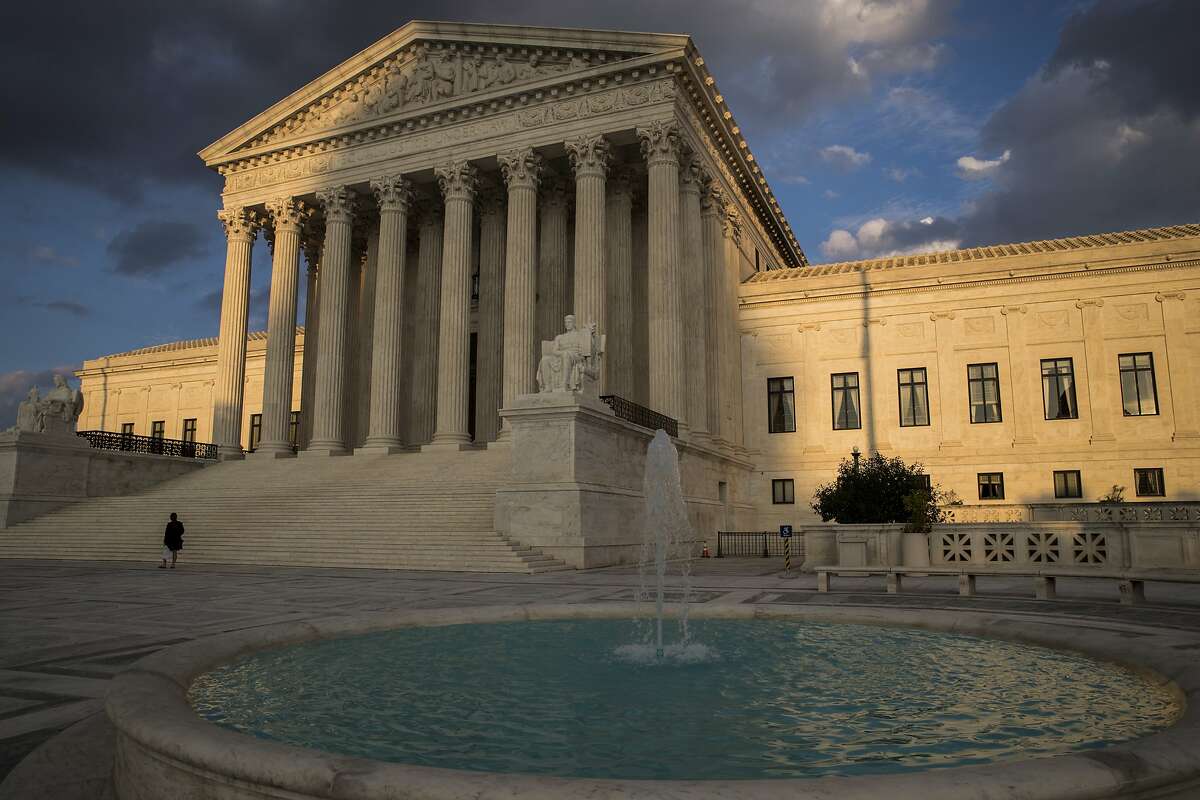 FILE - In this Oct. 10, 2017 file photo, the Supreme Court in Washington is seen at sunset. In a 5-4 decision Friday, The Supreme Court says police generally need a search warrant if they want to track criminal suspects' movements by collecting information about where they've used their cellphones. (AP Photo/J. Scott Applewhite)