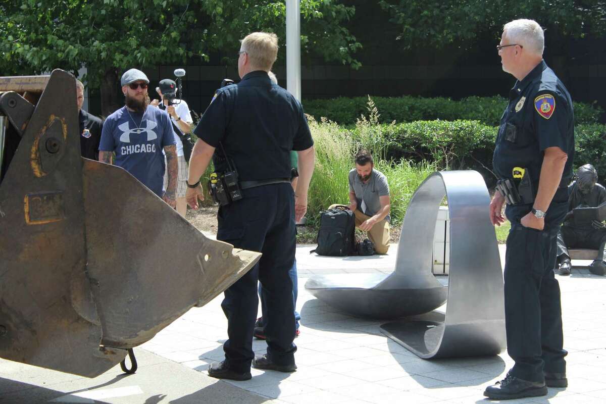 Protesters place giant heroin spoon outside Stamford’s Purdue Pharma