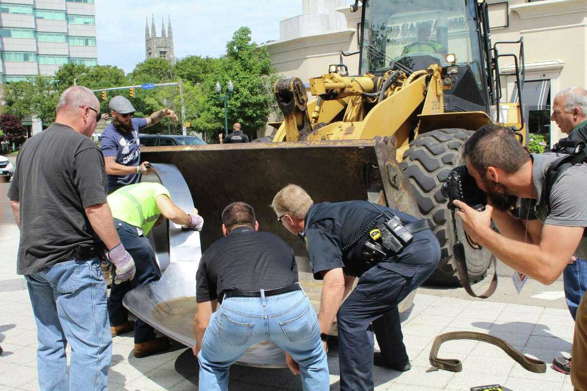 Protesters place giant heroin spoon outside Stamford’s Purdue Pharma
