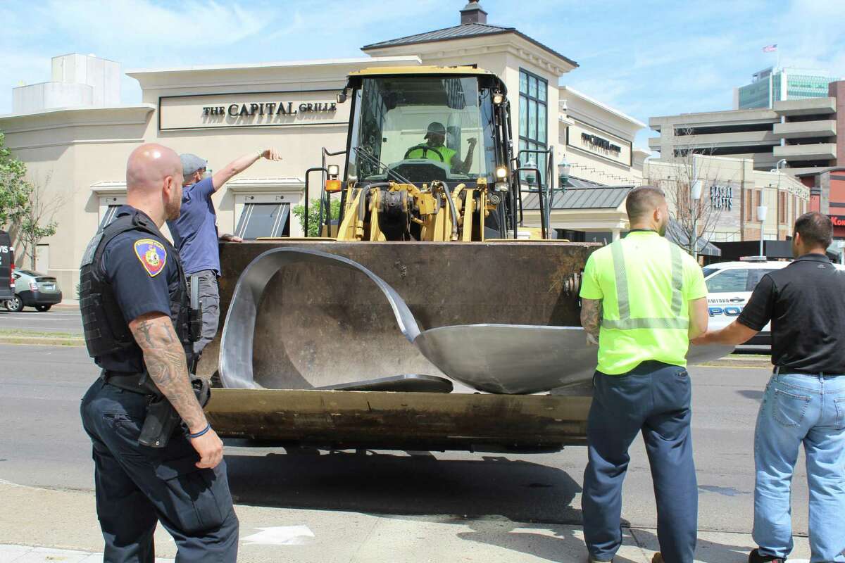 Protesters place giant heroin spoon outside Stamford’s Purdue Pharma