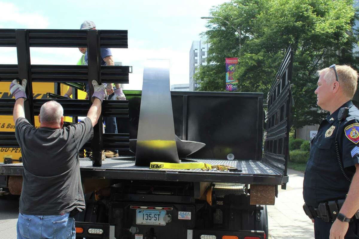 Protesters place giant heroin spoon outside Stamford’s Purdue Pharma