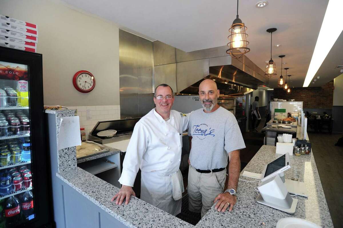 Teena's Apizza co-owners Derek Furino, left, and Kevin Romano pose for a photo inside their new eatery, at 245 Main St., in downtown Stamford, Conn., on Monday, June 18, 2018.