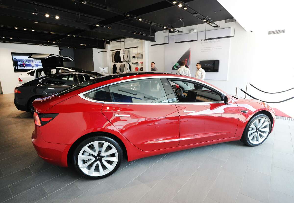 A Tesla Model 3 on display inside the Tesla Gallery at 340 Greenwich Ave., Greenwich, Conn., Friday, June 22, 2018. According to Car & Driver Magazine, the sale price for the electric rechargable battery-powered Model 3 is $36,000, it does 0- 60 mph in 5.1 seconds with a top speed of 141 mph and the rear-wheel-drive models travel about 220 miles on a single charge.