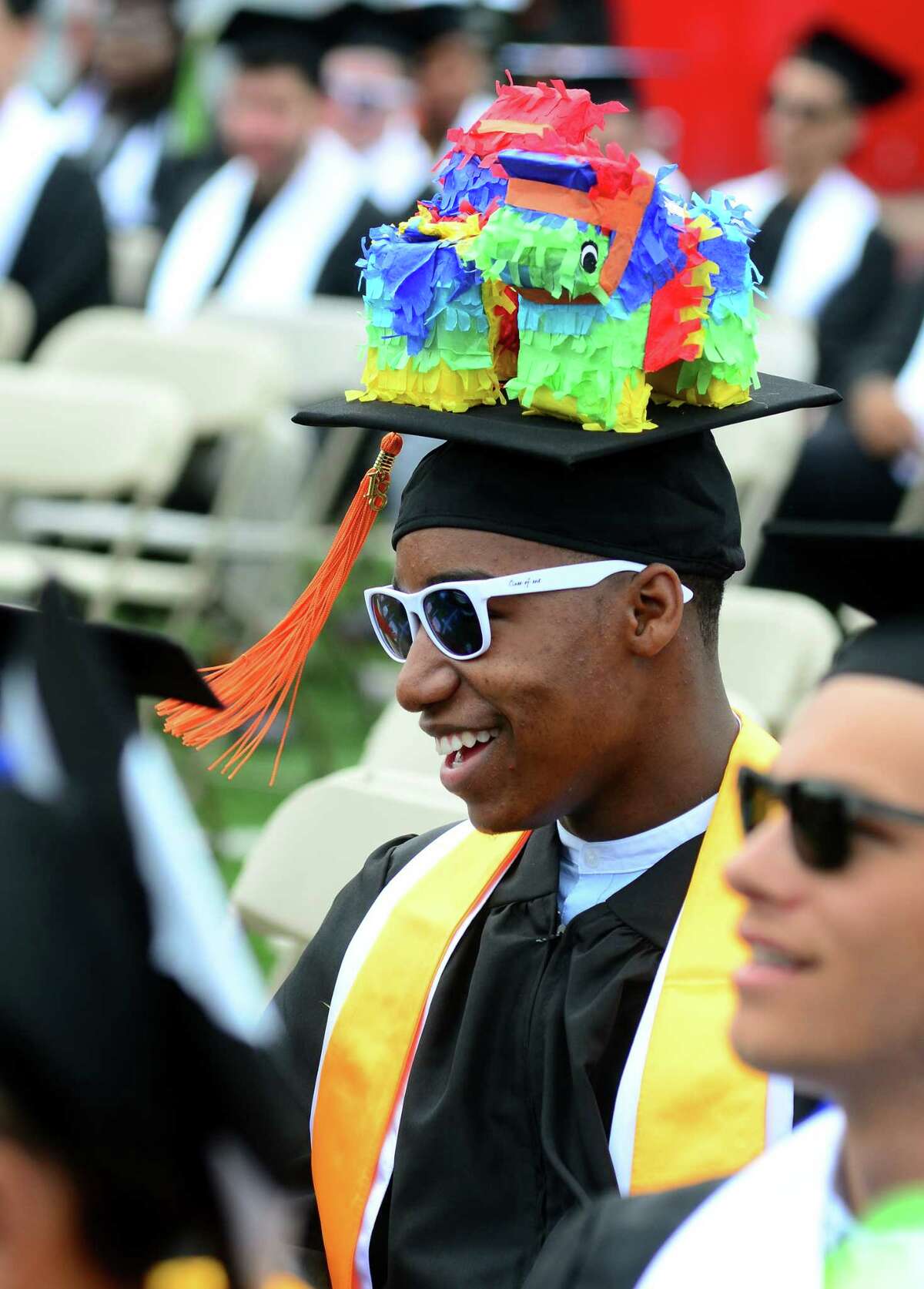Pinatas decorate the cap of graduate Isiaiah Smith, of Bridgeport, during the Interdistrict Science Magnet School's 3rd Annual Commencement Ceremony at Central High School's Kennedy Stadium in Bridgeport, Conn., on Friday June 22, 2018.