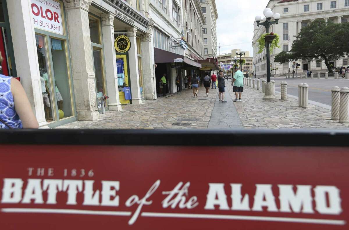 A sign explaining a part of the history of the battle of the Alamo sits June 21 on the Alamo Street sidewalk in Alamo Plaza. A design plan for the plaza is generating heat.