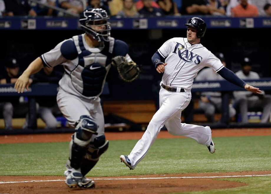 Tampa Bay Rays' Daniel Robertson, right, scores on a single by Willy Adames as New York Yankees catcher Gary Sanchez fields a wide throw during the fourth inning of a baseball game Friday, June 22, 2018, in St. Petersburg, Fla. (AP Photo/Chris O'Meara) Photo: Chris O'Meara / Copyright 2018 The Associated Press. All rights reserved.
