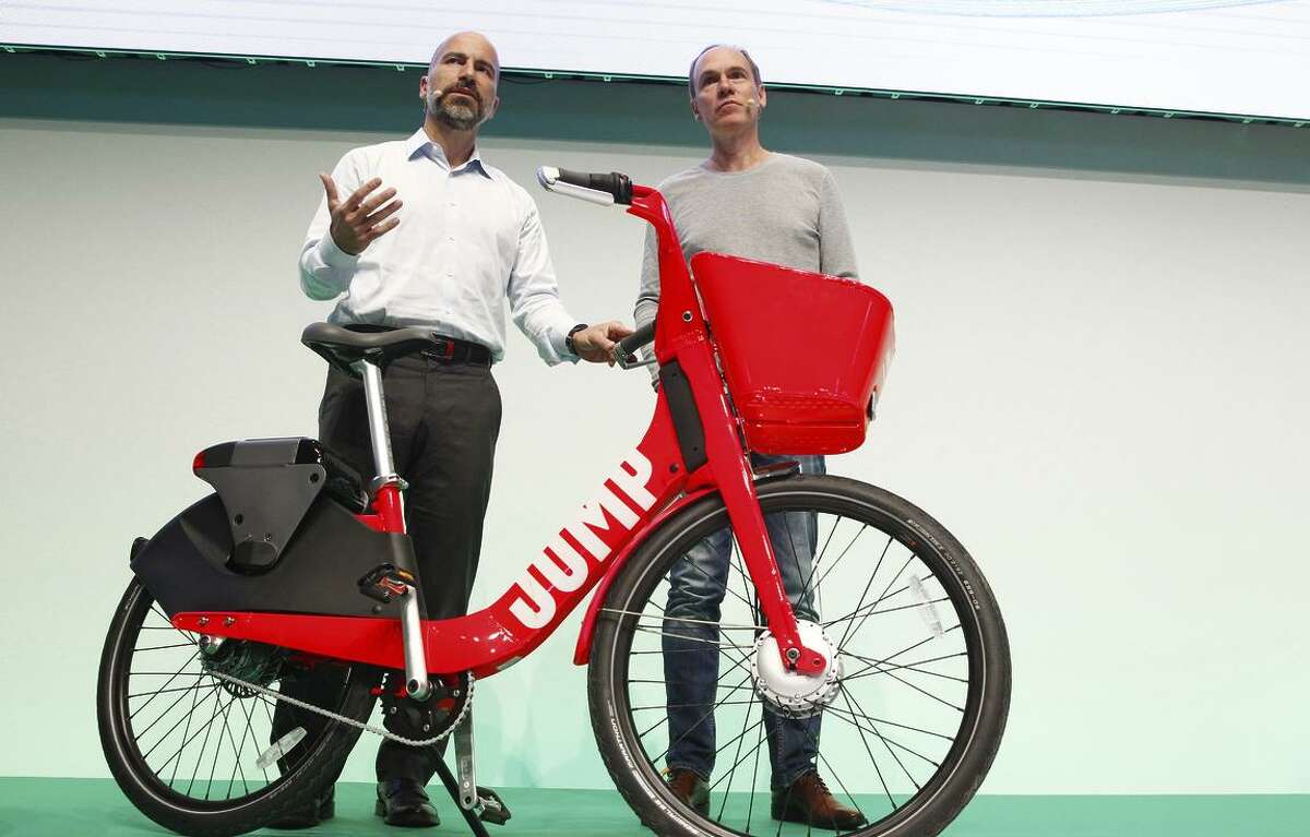 Uber CEO Dara Khosrowshahi (left) and Axel Springer CEO Christoph Keese show off Uber’s new bike sharing service, Jump. Uber wants to have scooters, too.