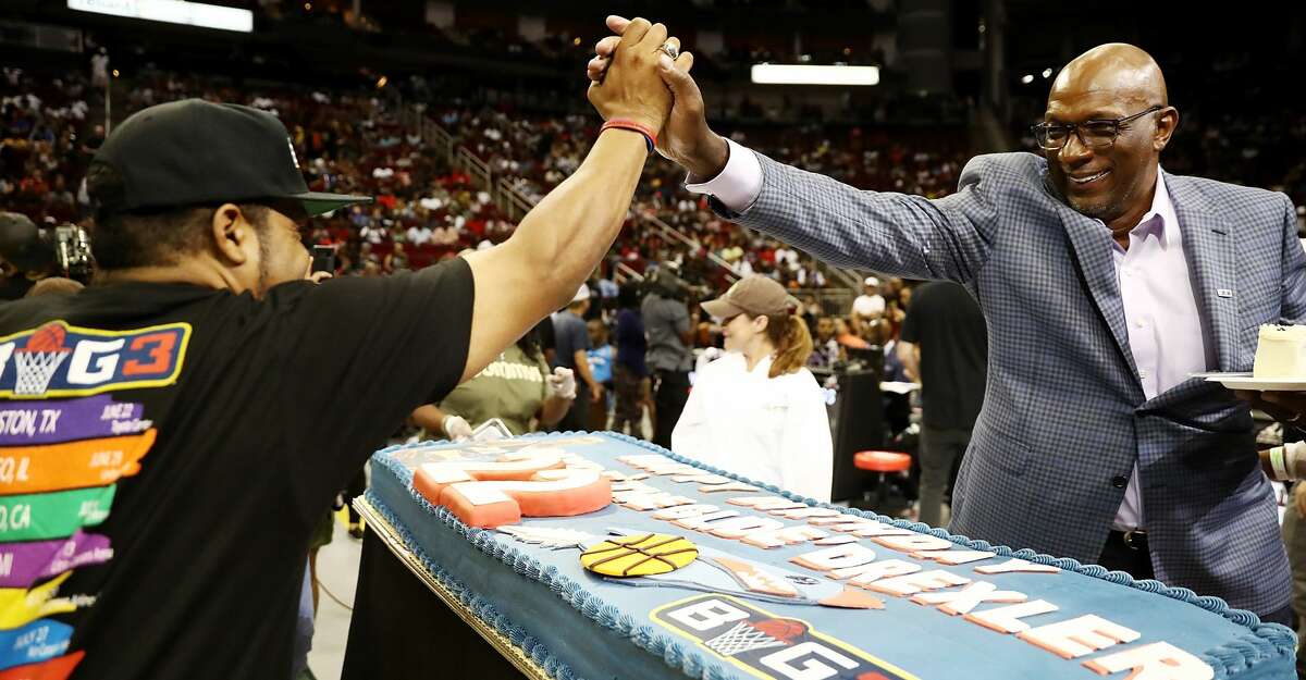 HOUSTON, TX - JUNE 22: BIG3 League Co-Founder, Ice Cube, presents Commissioner, Clyde Drexler, with a birthday cake during week one of the BIG3 three on three basketball league at Toyota Center on June 22, 2018 in Houston, Texas. (Photo by Ronald Martinez/BIG3/Getty Images)