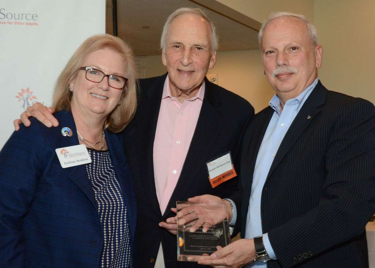 SilverSource Executive Director Kathleen Bordelon and Board Chair Jerome Berkman present Reyno A. Giallongo, Jr. First County Bank Chairman and CEO, and President of the First County Bank Foundation an award for outstanding community leadership.