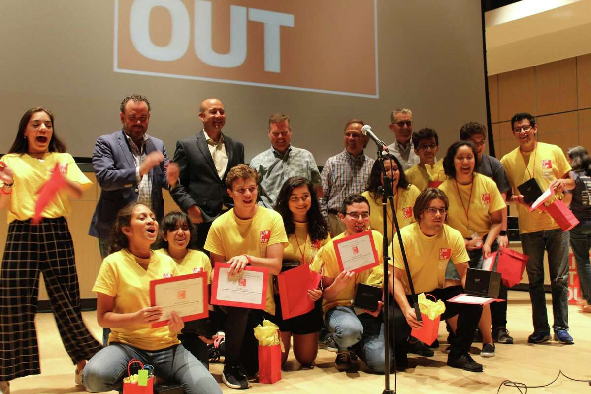 Team “Energy” (campers) pose in front of Live It Out board members at the closing ceremony on Friday, June 22, 2018