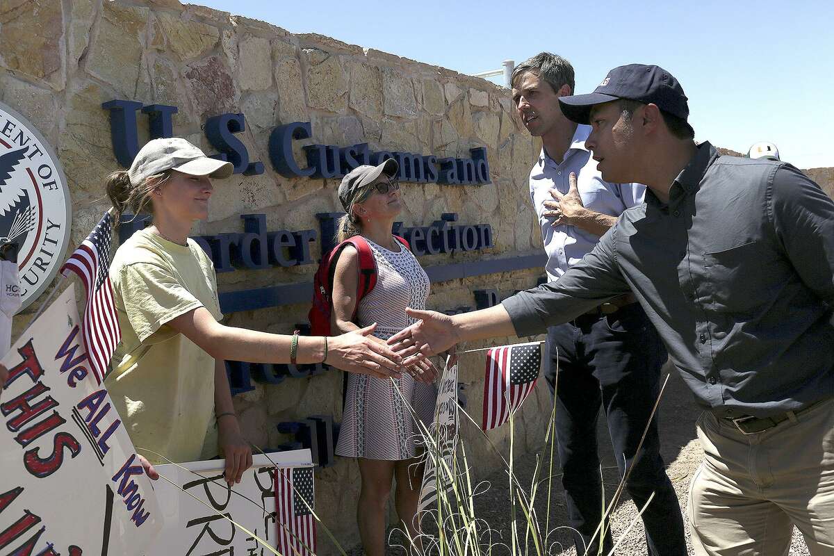 U.S. Rep. Joaquin Castro, right, shakes the hand of Cass Kostelnik, 15, while U.S. Rep. Beto O'Rourke speaks with her mother, Megan Matson, of Bolinas, CA, after the Congressmen toured the "tent city," built to house immigrant children separated from their parents after crossing illegally into the U.S. or seeking asylum, at the Marcelino Serna Port of Entry in Tornillo on June 23, 2018.