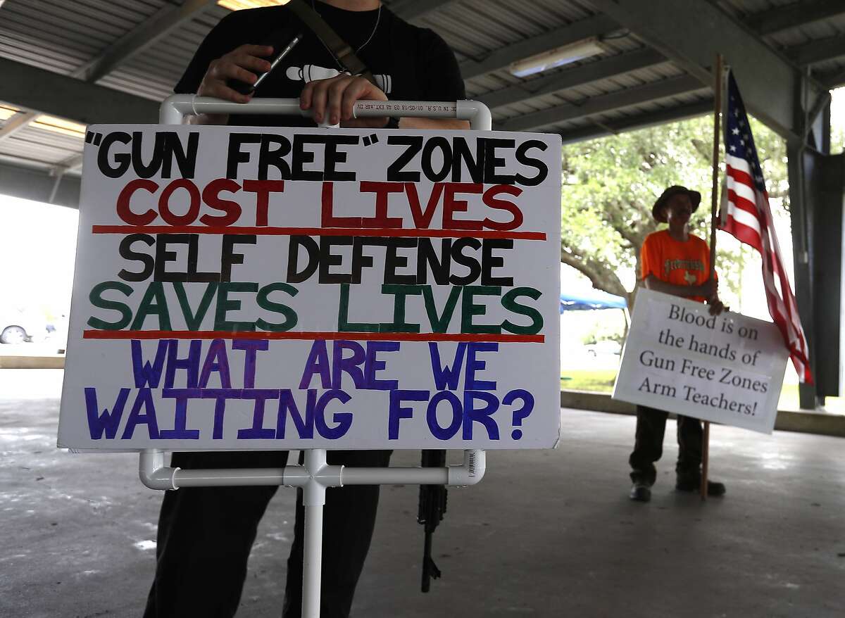 David Treibs, of Fredricksburg, in the background with an American flag during a pro-gun rally, at Runge Park Saturday, June 23, 2018, in Santa Fe. This Is Texas Freedom Force (TITFF) invited the public in Santa Fe & surrounding areas to join the discussion about arming teachers and school staff. ( Karen Warren / Houston Chronicle )