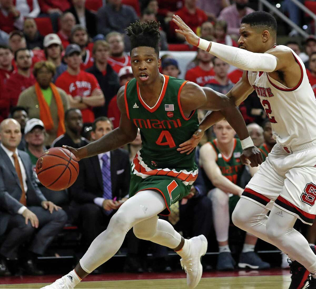 FILE - In this Jan. 21, 2018, file photo, Miami's Lonnie Walker IV (4) drives the ball around North Carolina State's Allerik Freeman (12) during the second half of an NCAA college basketball game in Raleigh, N.C. Walker is a possible pick in Thursday's NBA Draft. (AP Photo/Karl B DeBlaker, File)