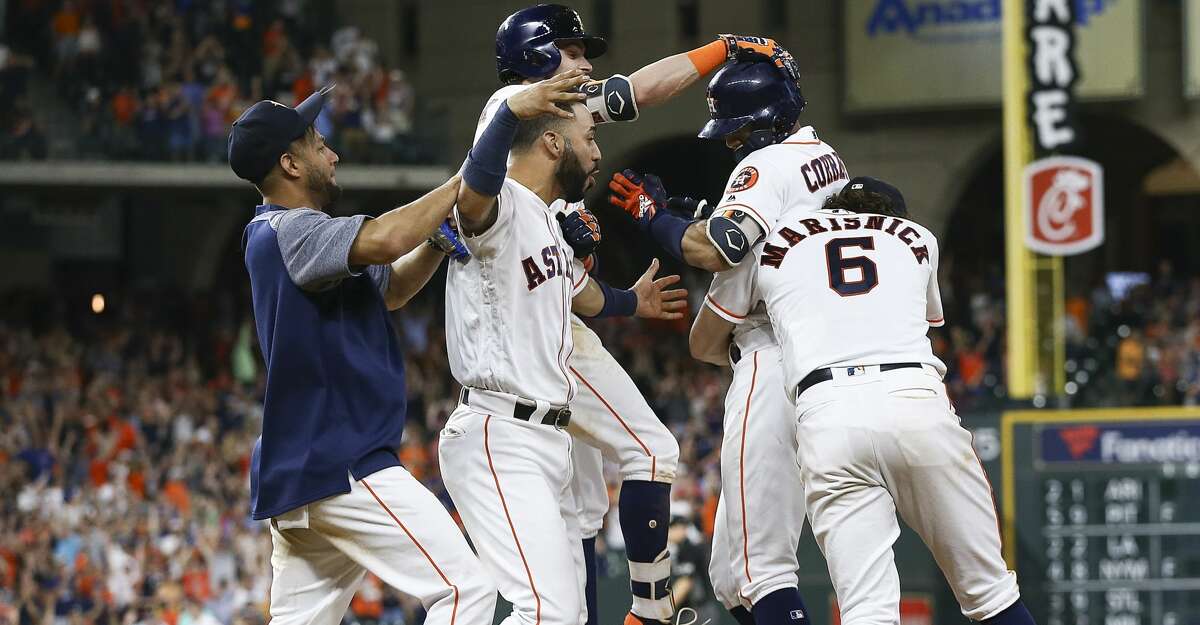 HOUSTON, TX - JUNE 23: Carlos Correa #1 of the Houston Astros is hugged by Jake Marisnick #6, Josh Reddick #22,Marwin Gonzalez and Yuli Gurriel #10 after hitting a walkoff single in the twelfth inning for a 4-3 win against the Kansas City Royals at Minute Maid Park on June 23, 2018 in Houston, Texas. (Photo by Bob Levey/Getty Images)