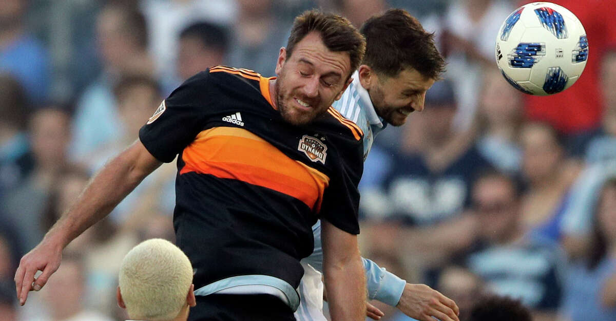 Houston Dynamo midfielder Eric Alexander, top left, heads the ball against Sporting Kansas City midfielder Ilie Sanchez, top right, during the first half of an MLS soccer match in Kansas City, Kan., Saturday, June 23, 2018. (AP Photo/Orlin Wagner)