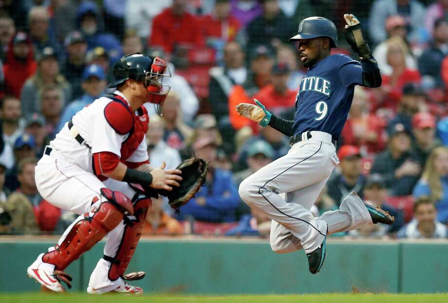 Seattle Mariners' Dee Gordon (9) scores on a double by Mitch Haniger as Boston Red Sox's Christian Vazquez, left, waits for the throw during the first inning of a baseball game in Boston, Saturday, June 23, 2018. (AP Photo/Michael Dwyer) Photo: Michael Dwyer / Copyright 2018 The Associated Press. All rights reserved