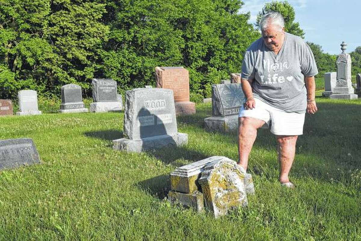 Sandy Winner of Jacksonville looks at one of the gravestones that needs to be repaired in Union Baptist Cemetery near Pisgah. Winner and two others are trying to raise money to restore some of the broken tombstones in the old cemetery.
