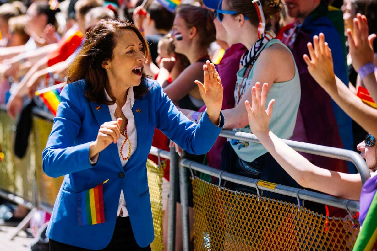 Sen. Maria Cantwell interacts with spectators at the 2018 Seattle Pride Parade.