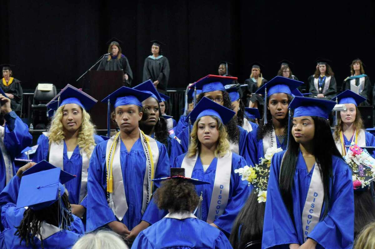 A number of Albany High School graduates stand and turn their back on Sue Adler, background left, the president of the Board of Education, as she gave a speech at the Albany High School graduation at the Times Union Center on Sunday, June 24, 2018, in Albany, N.Y. (Paul Buckowski/Times Union)