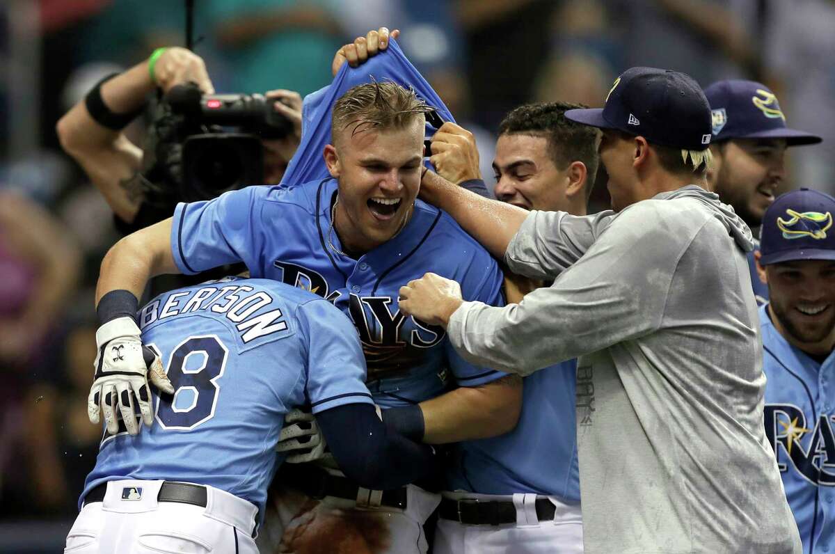 Tampa Bay Rays' Jake Bauers, center, celebrates with teammates after his walkoff home run off New York Yankees relief pitcher Chasen Shreve during the 12th inning of a baseball game Sunday, June 24, 2018, in St. Petersburg, Fla. (AP Photo/Chris O'Meara)