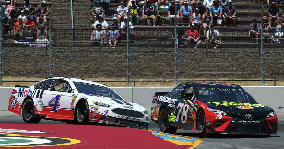 Martin Truex Jr. (78) leads Kevin Harvick (4) through a turn during a NASCAR Sprint Cup Series auto race Sunday, June 24, 2018, in Sonoma, Calif. (AP Photo/Ben Margot) Photo: Ben Margot / Copyright 2018 The Associated Press. All rights reserved.