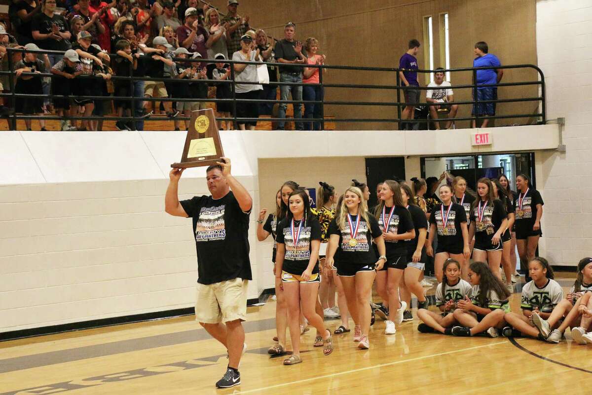 Coach Joe Slack leads a procession of the Lady Panthers June 21 with the state championship plaque over his head and the girls following. They entered to a standing ovation and cheers.