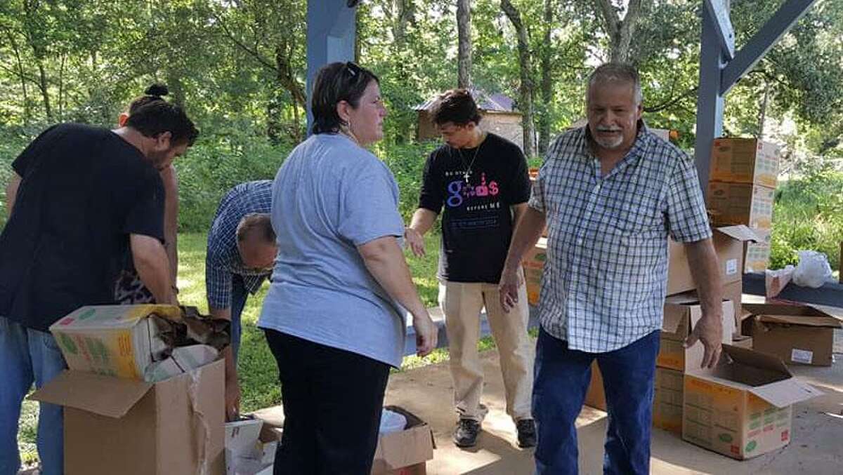 Volunteers from the Covenant with Christ and a local Cowboy Church prepare to serve food to residents in Camilla on June 16. Many Camilla residents are still handling the after effects of Hurricane Harvey.