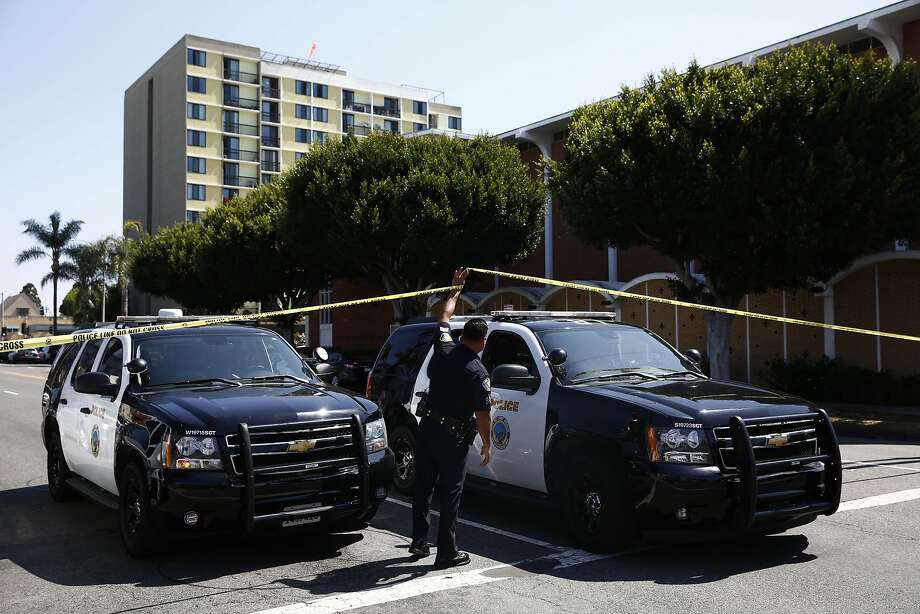 Long Beach police keep a street closed off near a retirement home, seen in background on Monday, June 25, 2018, in Long Beach, Calif. A resident of the retirement home in Southern California opened fire on firefighters responding to a report of an explosion in the building, killing a veteran fire captain and wounding a second firefighter and another person, officials said. (AP Photo/Jae C. Hong) Photo: Jae C. Hong, Associated Press