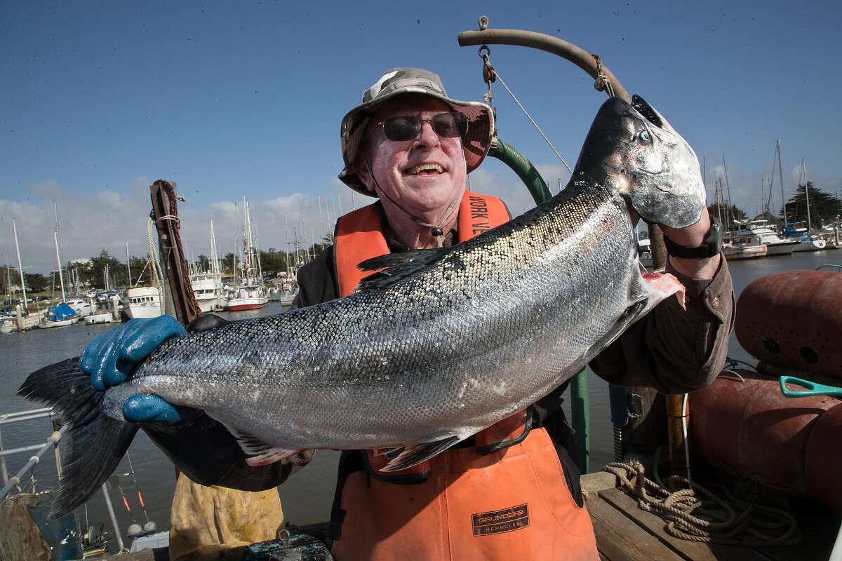 Fisherman Tom Eckert holds a California king salmon in Moss Landing in 2018.