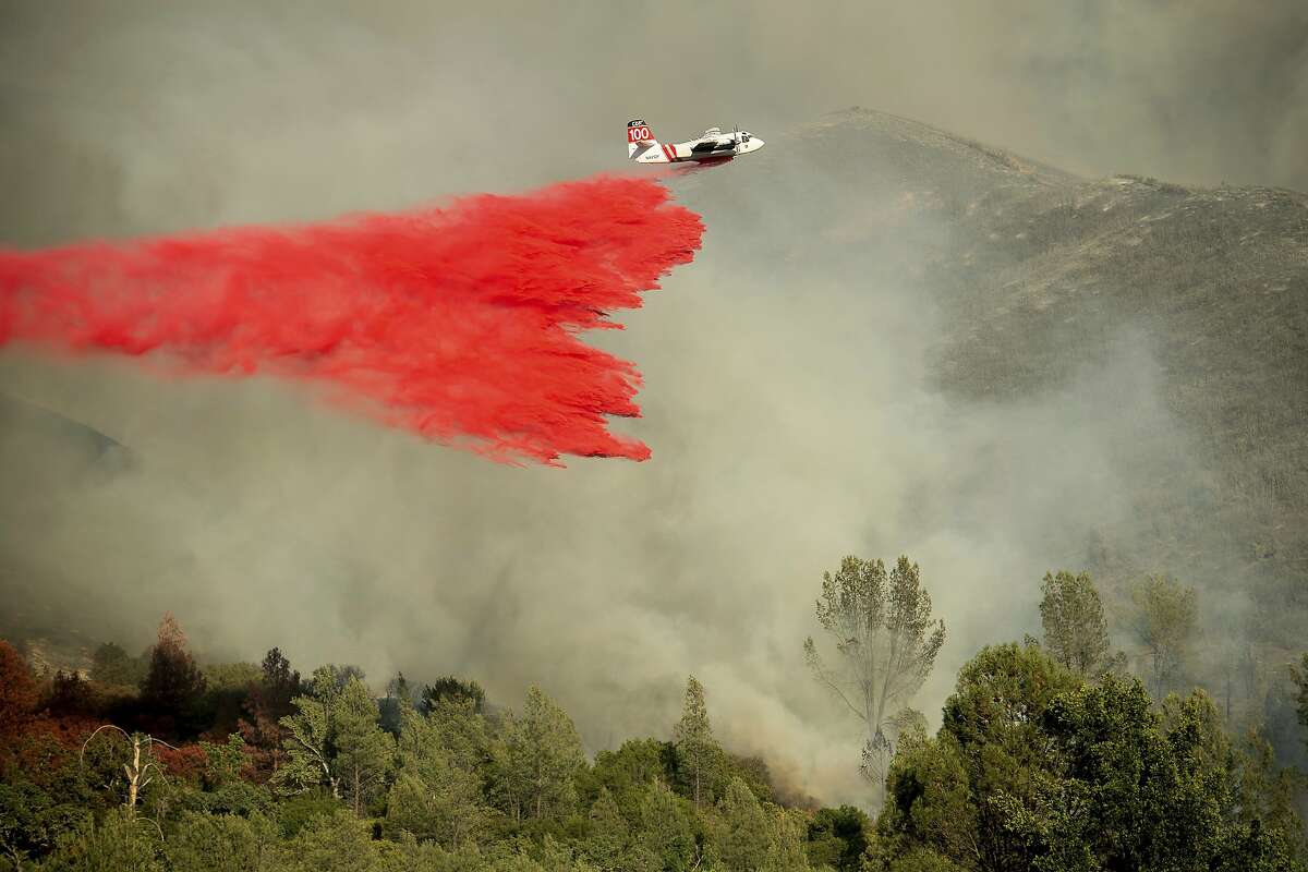 An air tanker drops retardant on a wildfire burning above the Spring Lakes community on June 24, 2018, near Clearlake Oaks.