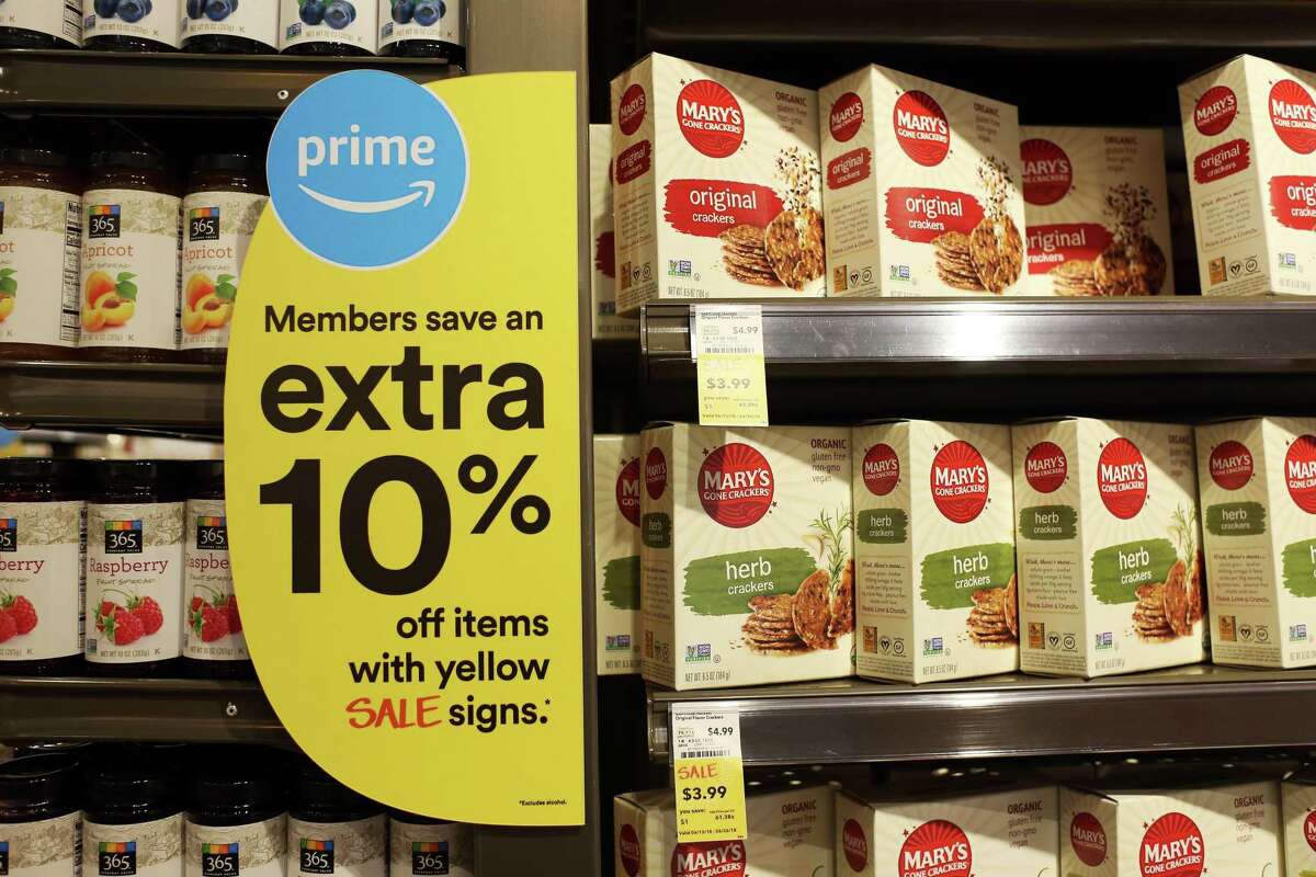 A sign alerts Amazon.com Inc. Prime members of savings during the grand opening of a Whole Foods Market Inc. location in Burbank, California, U.S., on Wednesday, June 20, 2018. Customer traffic was up 2.4 percent at Whole Foods stores during the first five months of 2018, a sign that Amazon has managed to draw in new shoppers with ballyhooed price cuts on a handful of items. Photographer: Dania Maxwell/Bloomberg