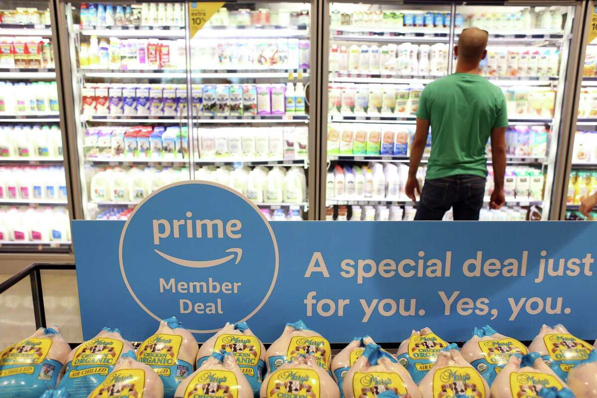 A sign alerts Amazon.com Inc. Prime members of a special deal on organic chickens during the grand opening of a Whole Foods Market Inc. location in Burbank, California, U.S., on Wednesday, June 20, 2018. Customer traffic was up 2.4 percent at Whole Foods stores during the first five months of 2018, a sign that Amazon has managed to draw in new shoppers with ballyhooed price cuts on a handful of items. Photographer: Dania Maxwell/Bloomberg