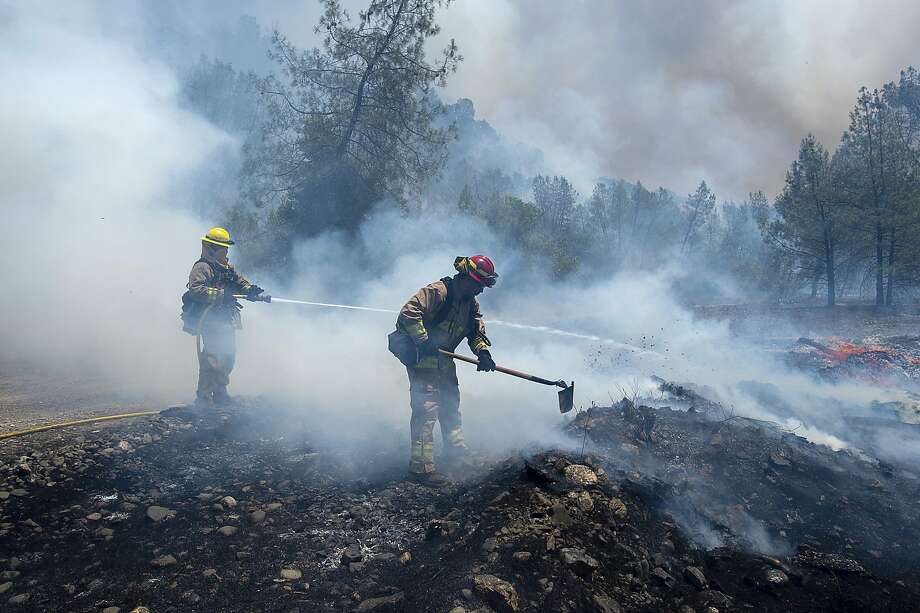 Fire crews battle a wildfire near Cache Creek Road in Spring Valley, Calif., Monday, June 25, 2018. Thousands were forced to flee their homes Monday as major wildfires encroached on a charred area of Northern California still recovering from severe blazes in recent years, sparking concern the state may be in for another destructive series of wildfires this summer. (Paul Kitagaki Jr./The Sacramento Bee via AP) Photo: Paul Kitagaki Jr. / Associated Press