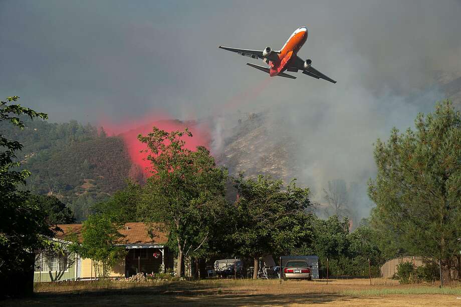 a cal fire jet dumps fire retardant as they battle the pawnee