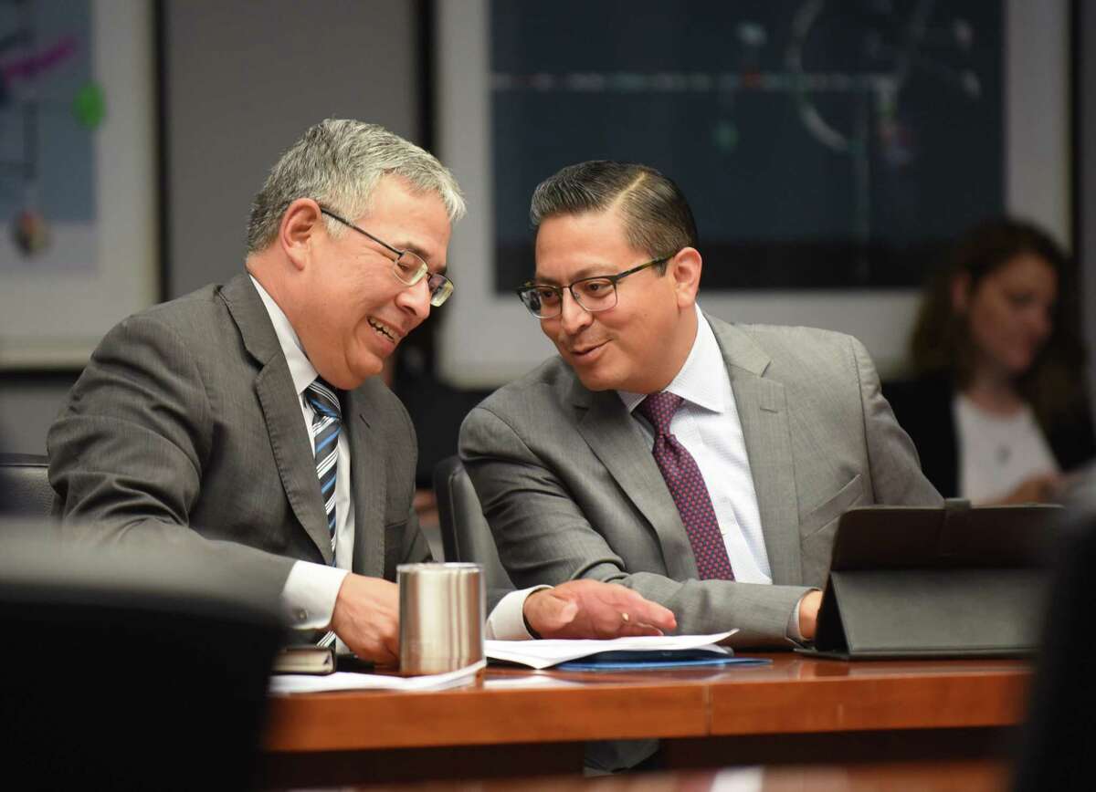 City Attorney Andy Segovia (left) and Edward Guzman, deputy city attorney, talk after the meeting of City Council’s Public Safety Committee on possible ways to reduce gun violence in San Antonio.