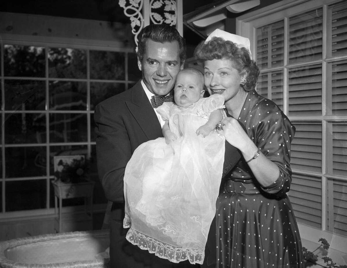(Original Caption) 10/2/1951-Hollywood, California-Bandleader Desi Arnaz and his actress wife, Lucillle Ball, pose withtheir new daughter for the baby's first picture. The couple combined their first names and came up with the name Lucie Desiree Arnaz.