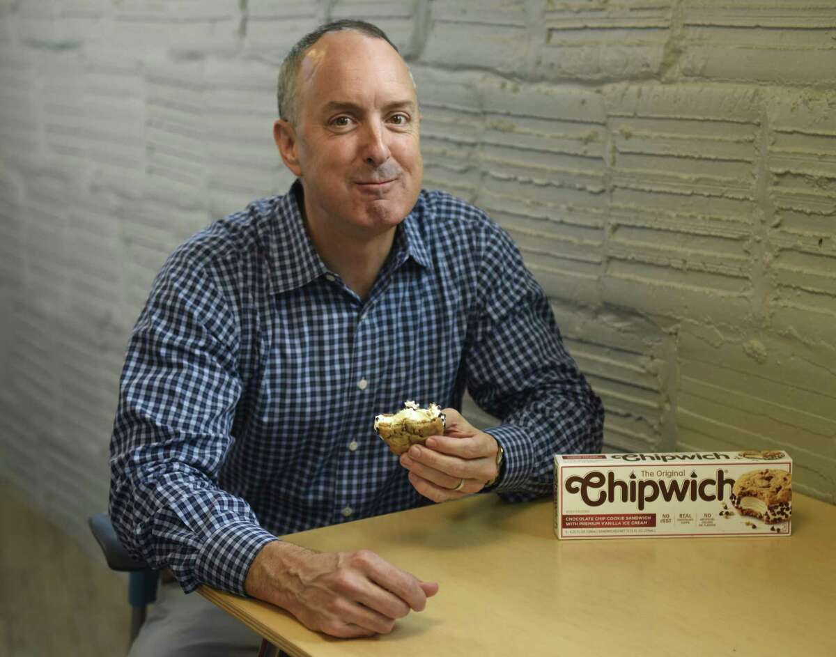 Crave Better Foods CEO David Clarke eats a Chipwich at the Comradity co-working space in Stamford, Conn. Tuesday, June 19, 2018. After a seven year hiatus, the classic ice cream cookie sandwich has returned after being acquired and relaunched by Crave Better Foods.